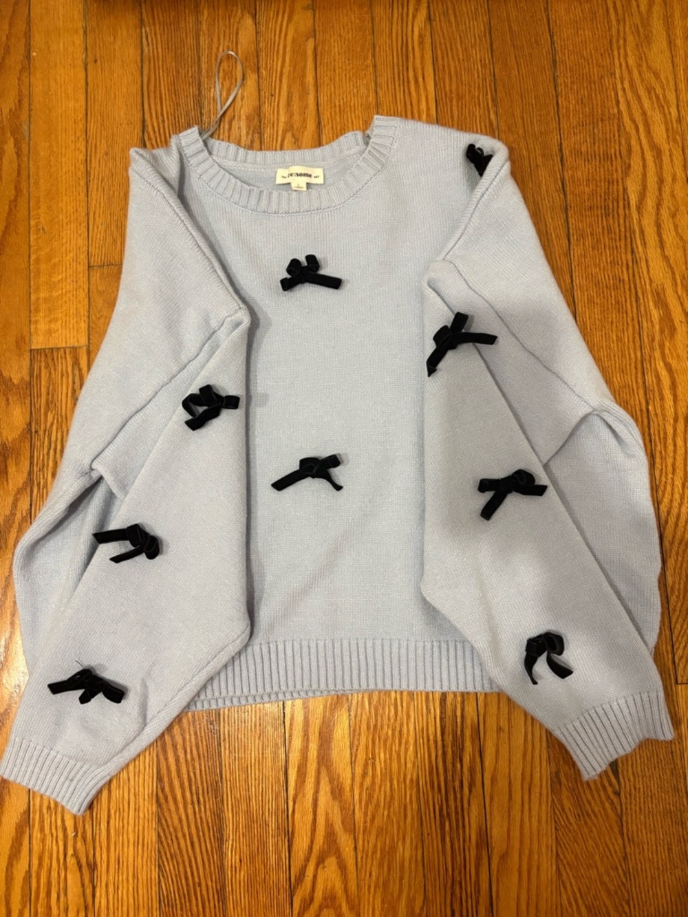 eesome Light Blue Crewneck Sweater with Black Bow Accents